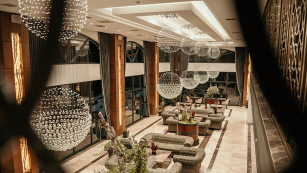 A spacious lobby with multiple seating areas, large chandeliers, and a grand staircase. - Grand Vaves Otel (Trabzon)