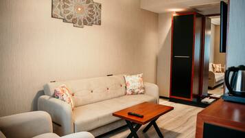 A modern living room with a sofa, a coffee table, and a decorative wall piece.