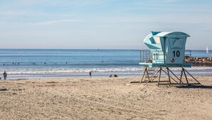 A lifeguard tower with the number 10 on a beach.