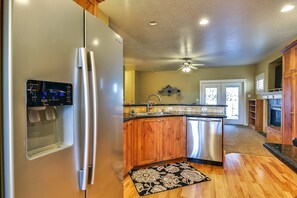 Enjoy cooking in this well-equipped kitchen with a refrigerator, ice and water dispenser, and dishwasher.
