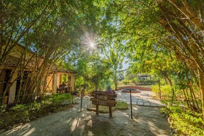 A bamboo archway leading to a building with a sign reading "Serai Tiger." - Camp Serai Tiger Tadoba (Bhadravathi)