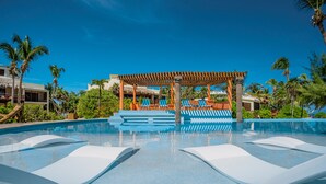 A pool area with lounge chairs, a pergola, and palm trees. - San Pedro 5-bedroom, 4-bathroom Villa Pearl, ocean views, concierge onsite (San Pedro)