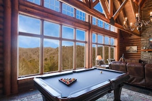 Relax by the window with a panoramic view of the forest, or challenge friends to a game of pool.