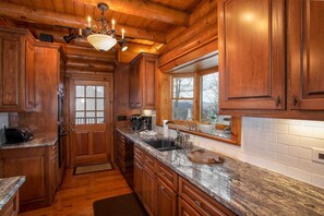Enjoy cooking in this well-equipped kitchen with a sink, coffee maker, and toaster.