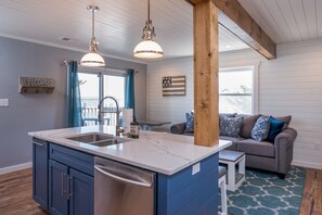 A modern kitchen with a central island, built-in appliances, and pendant lighting. - Kristy Greg Unit 3 - Unique coastal retreat ... Ocean Block! (Ocean City)