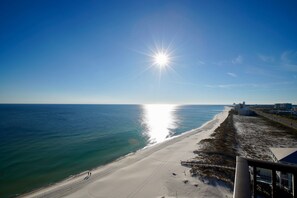 A beach with a clear sky, a bright sun, and a sandy shore. - Broadmoor 1205 -A View to Die For, Clean Bed Every Stay- Signature Properties (Orange Beach)