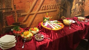 A buffet table with various dishes and a large 'Havana' sign in the background. - Havana Hotel Cairo (Giza)
