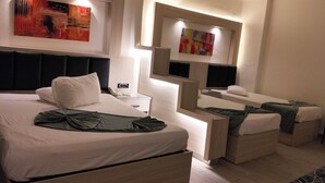 A modern hotel room with a large bed, bedside tables, a desk, and artwork on the walls. - Havana Hotel Cairo (Giza)