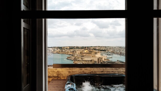 Ein Whirlpool mit Blick auf die Stadt durch ein Fenster.