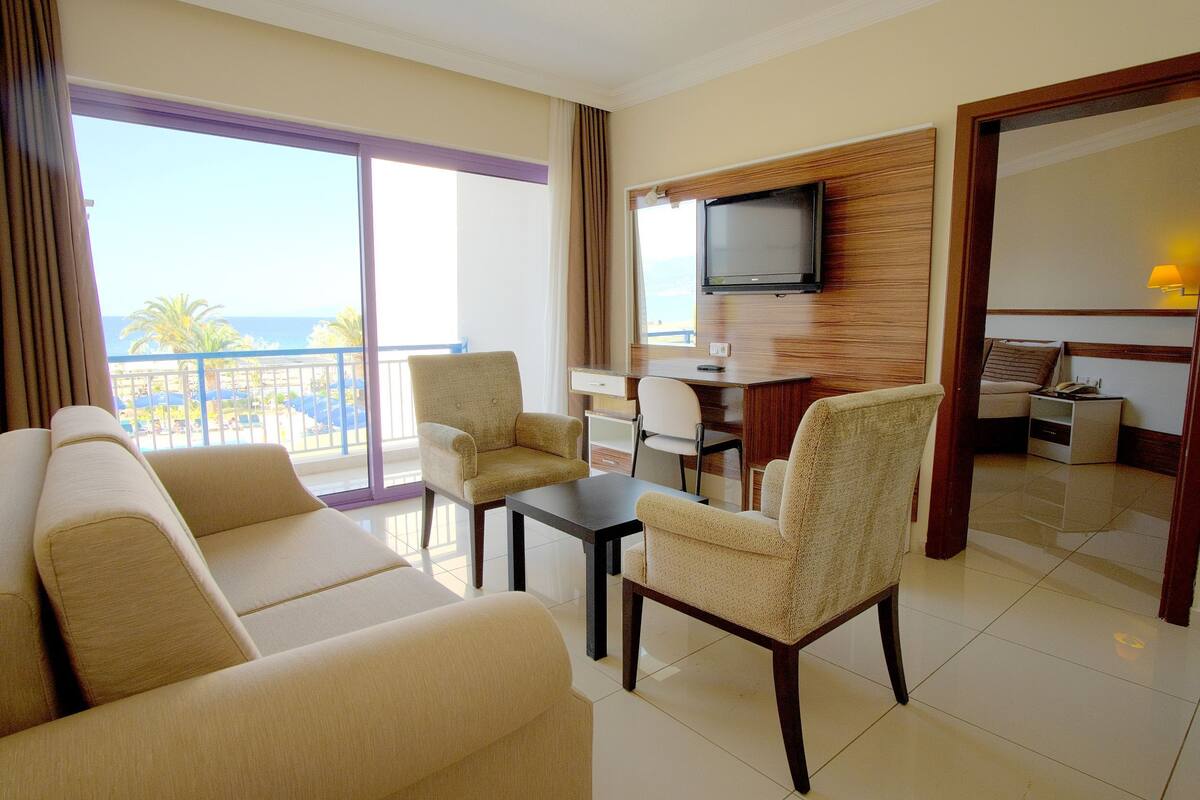 Family Suite, Multiple Beds, Connecting Rooms, Sea View | Living area | LCD TV, table tennis, books