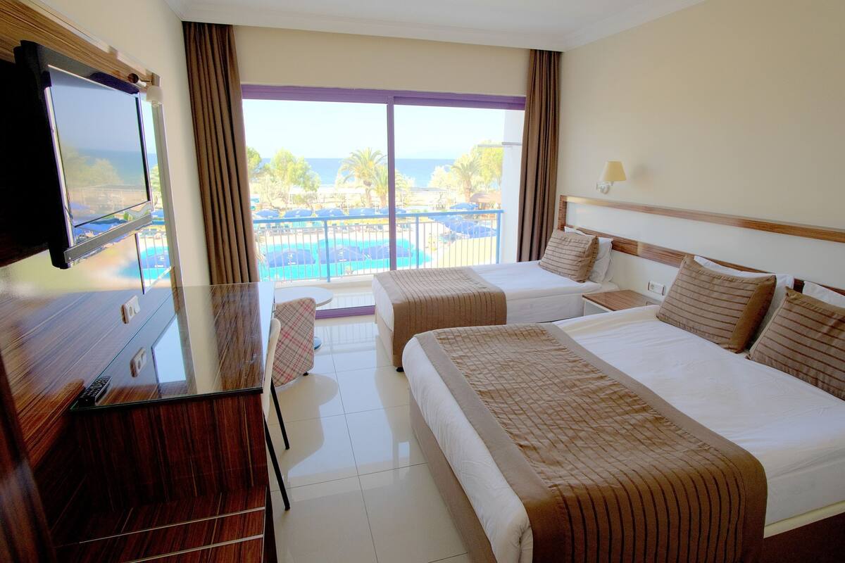 Deluxe Triple Room, 1 Bedroom, Balcony, Sea View | Hypo-allergenic bedding available, minibar, in-room safe, desk