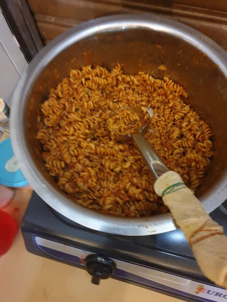 A pot of cooked pasta on a stove.