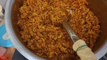 A pot of cooked pasta on a stove.