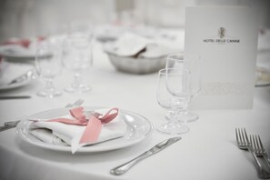 A dining table set with plates, cutlery, and a menu card labeled "HOTEL DELLE CANNE". - Hotel Delle Canne (Amantea)