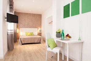 A modern bedroom with a bed, bedside table, and a TV mounted on the wall. - Domus Casaletto (Rome)