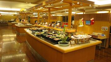 A buffet area with multiple serving stations, a variety of food options, and a clean, well-lit environment.
