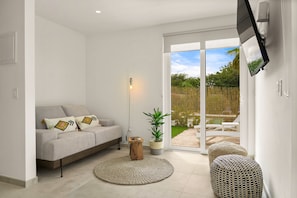 Premium Apartment, 1 Bedroom, Kitchen, Pool View | Living area | 55-inch flat-screen TV with cable channels, TV - Boca Catalina Modern Villa (Noord)