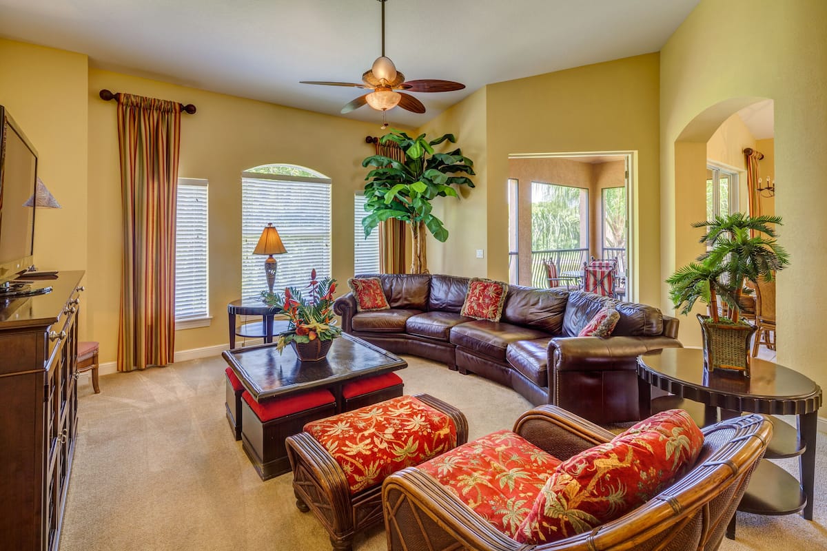 A living room with a sectional sofa, a coffee table, and a fireplace.