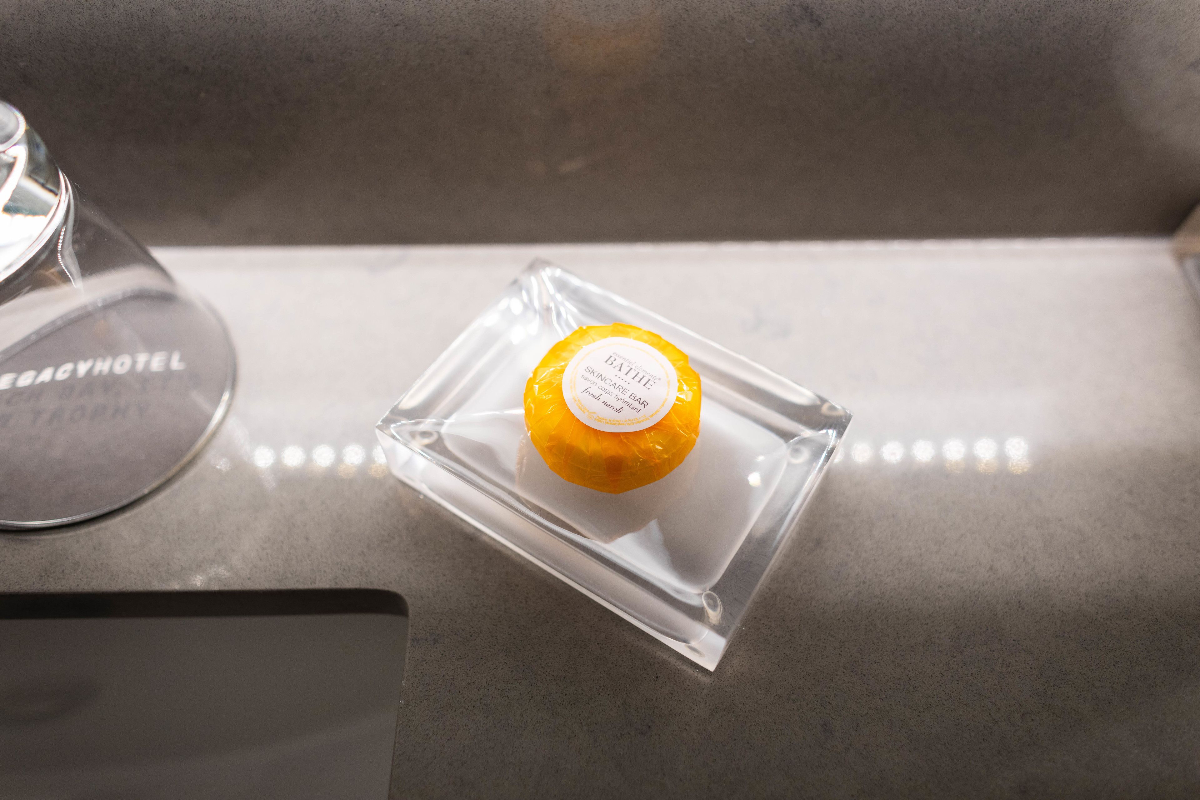 A clear glass container with a label on a countertop.