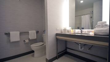 A modern bathroom with a toilet, sink, and shower area.