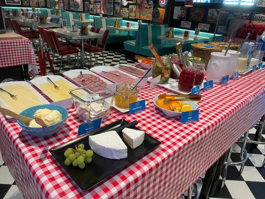 Una mesa de buffet con distintos alimentos y un mantel a cuadros.
