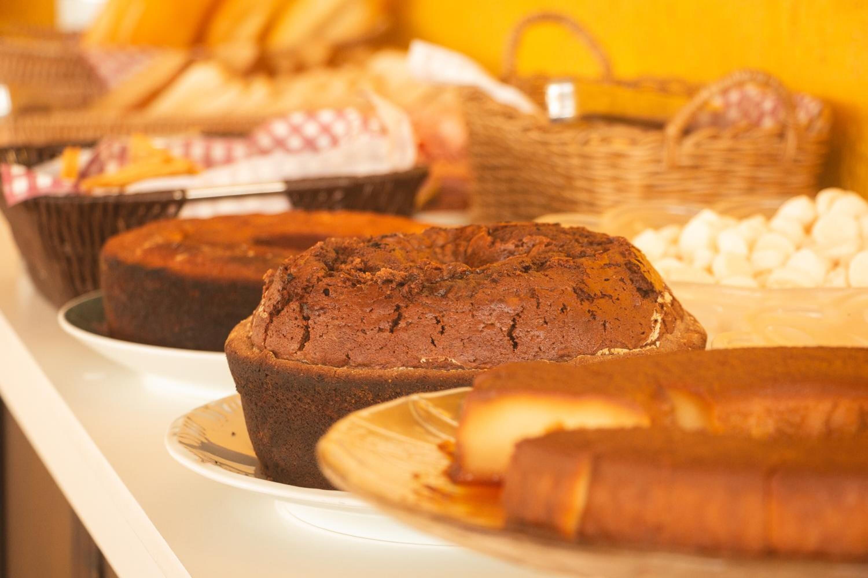 A display of baked goods including cakes and pastries.
