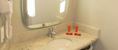 A bathroom with a sink, mirror, towel rack, and a hairdryer.