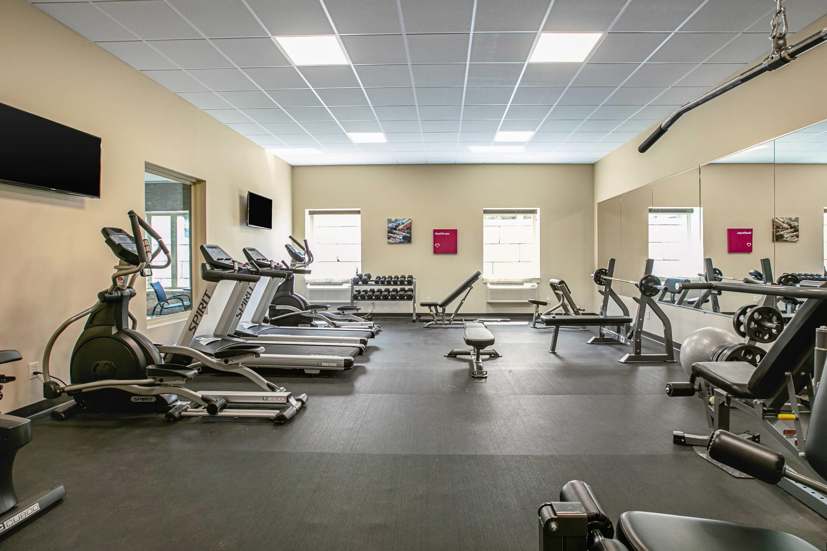A gym with treadmills, stationary bikes, and weight machines.