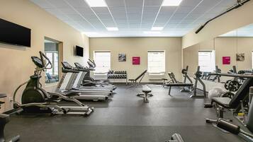 A gym with treadmills, stationary bikes, and weight machines.