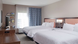 A hotel room with two beds, a desk, a TV, and a window with curtains. - Hampton Inn & Suites Overland Park South (Overland Park)