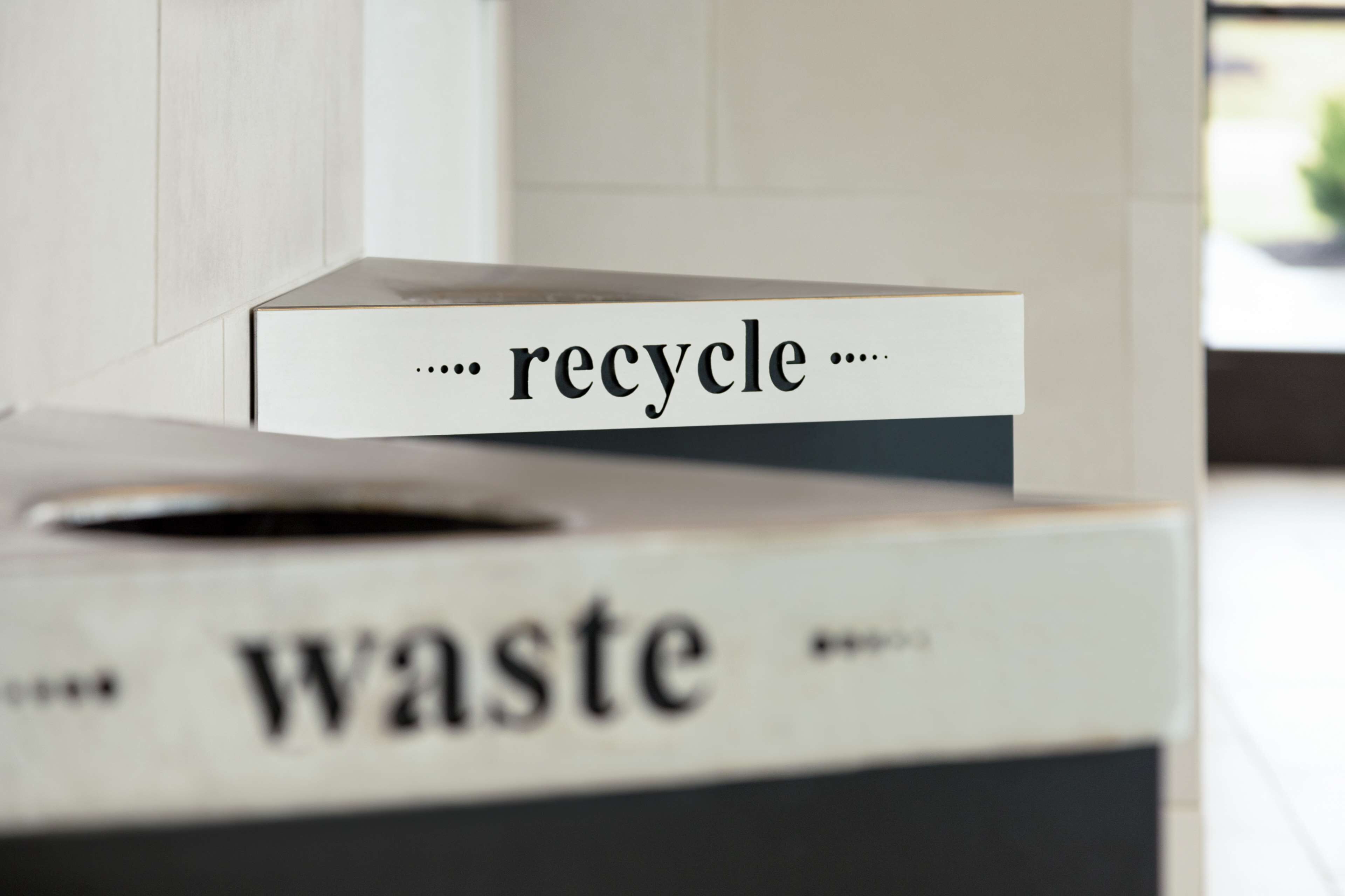 Un bote de basura con etiqueta de reciclaje.