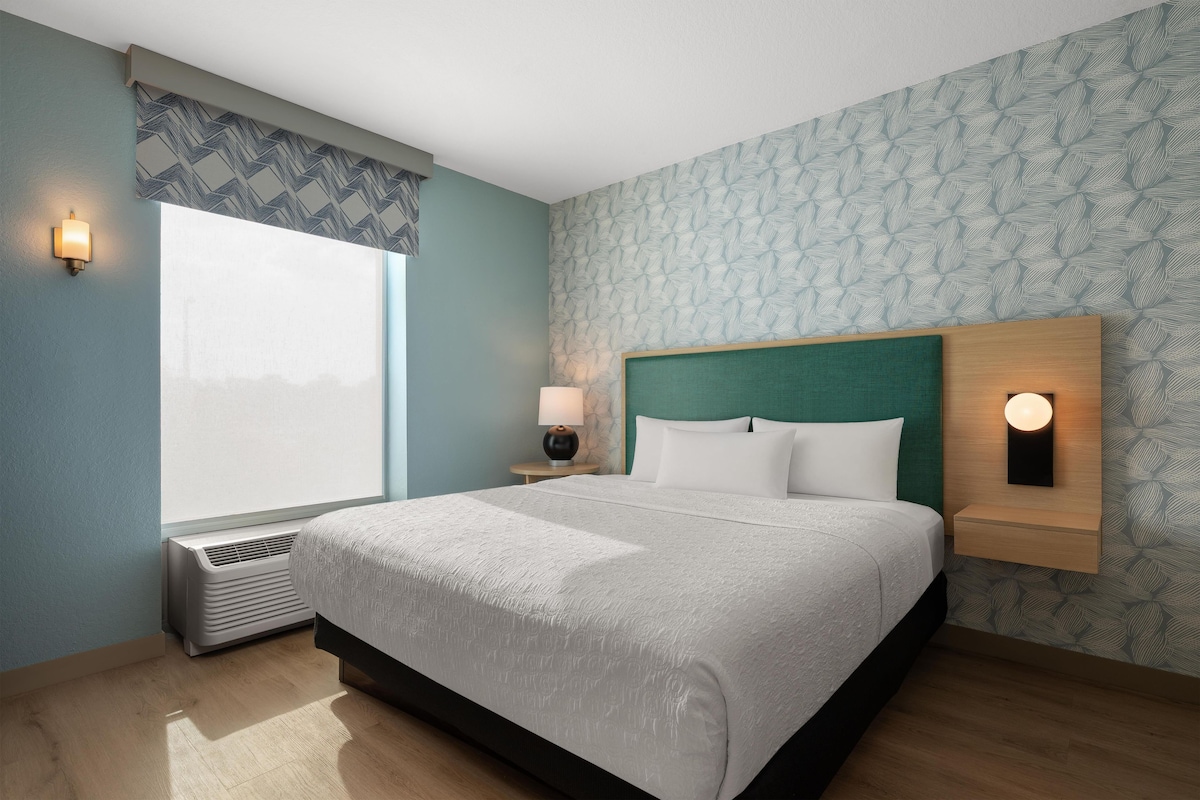 Premium bedding, desk, laptop workspace, blackout drapes