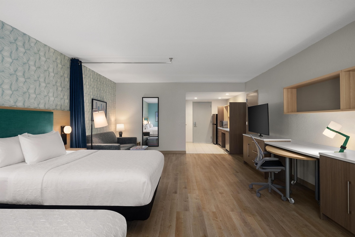 Premium bedding, desk, laptop workspace, blackout drapes