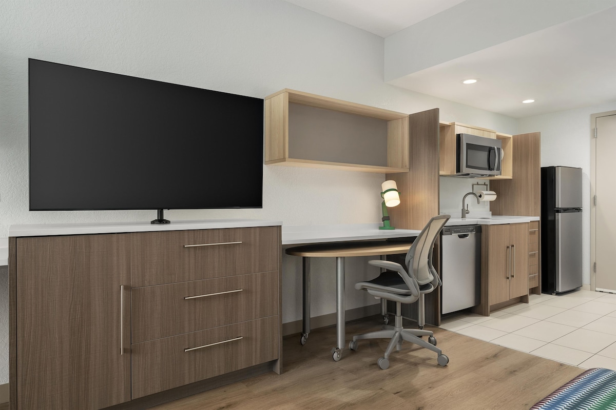 Premium bedding, desk, laptop workspace, blackout drapes