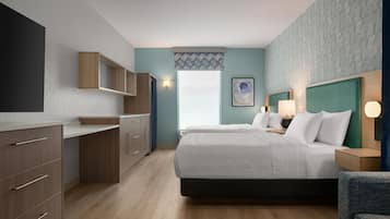 A hotel room with a bed, a desk, a wardrobe, and a large window.