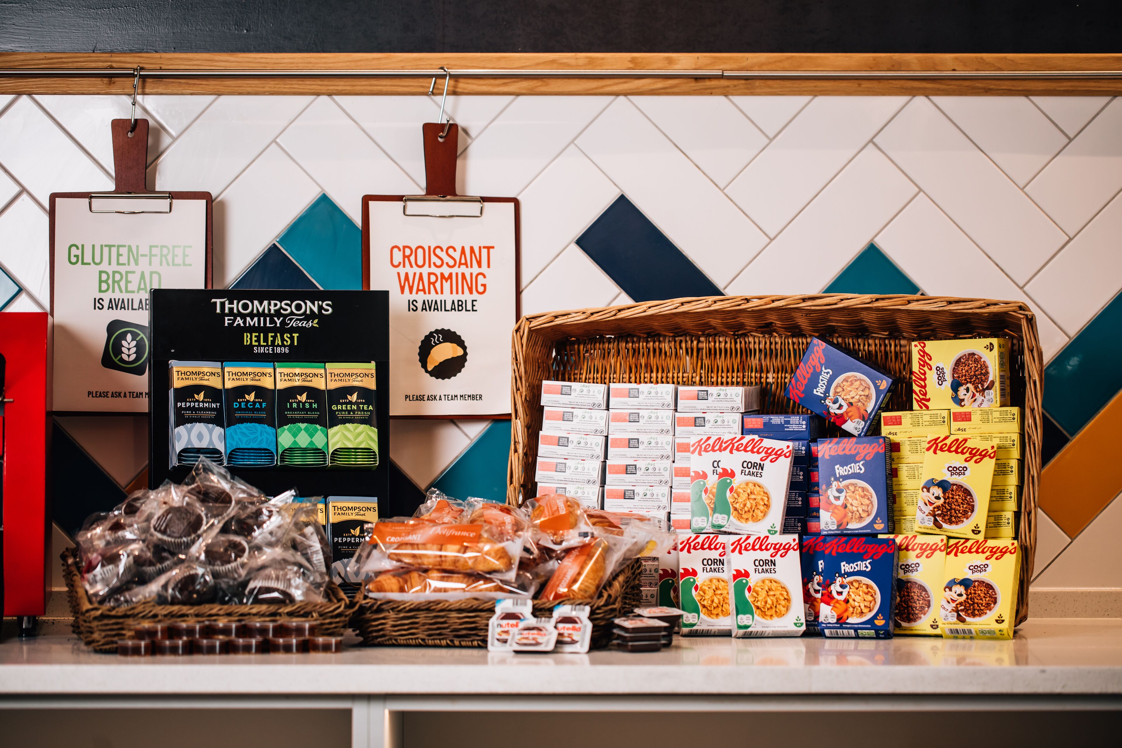 A display of gluten-free and croissant warming bread, along with various cereal boxes and snacks.