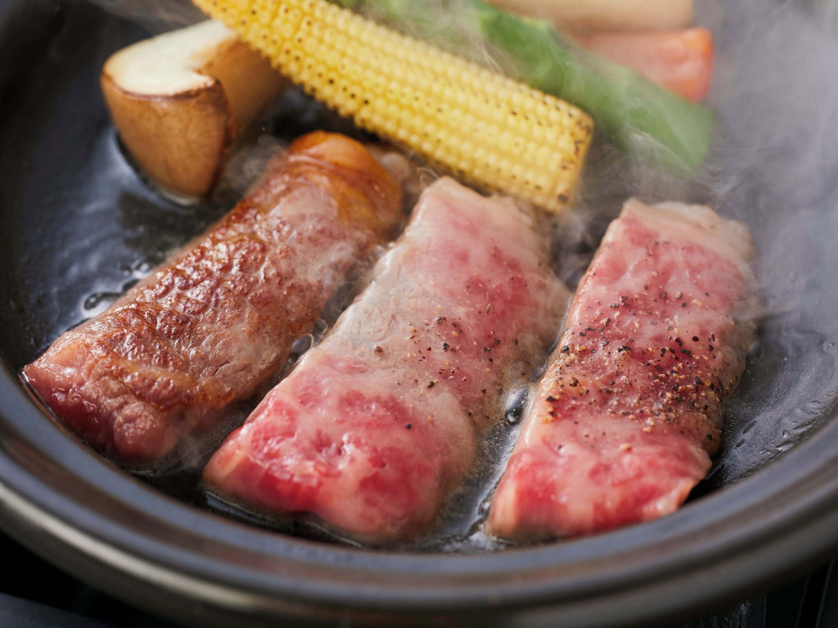 A cooking pot with meat and vegetables.