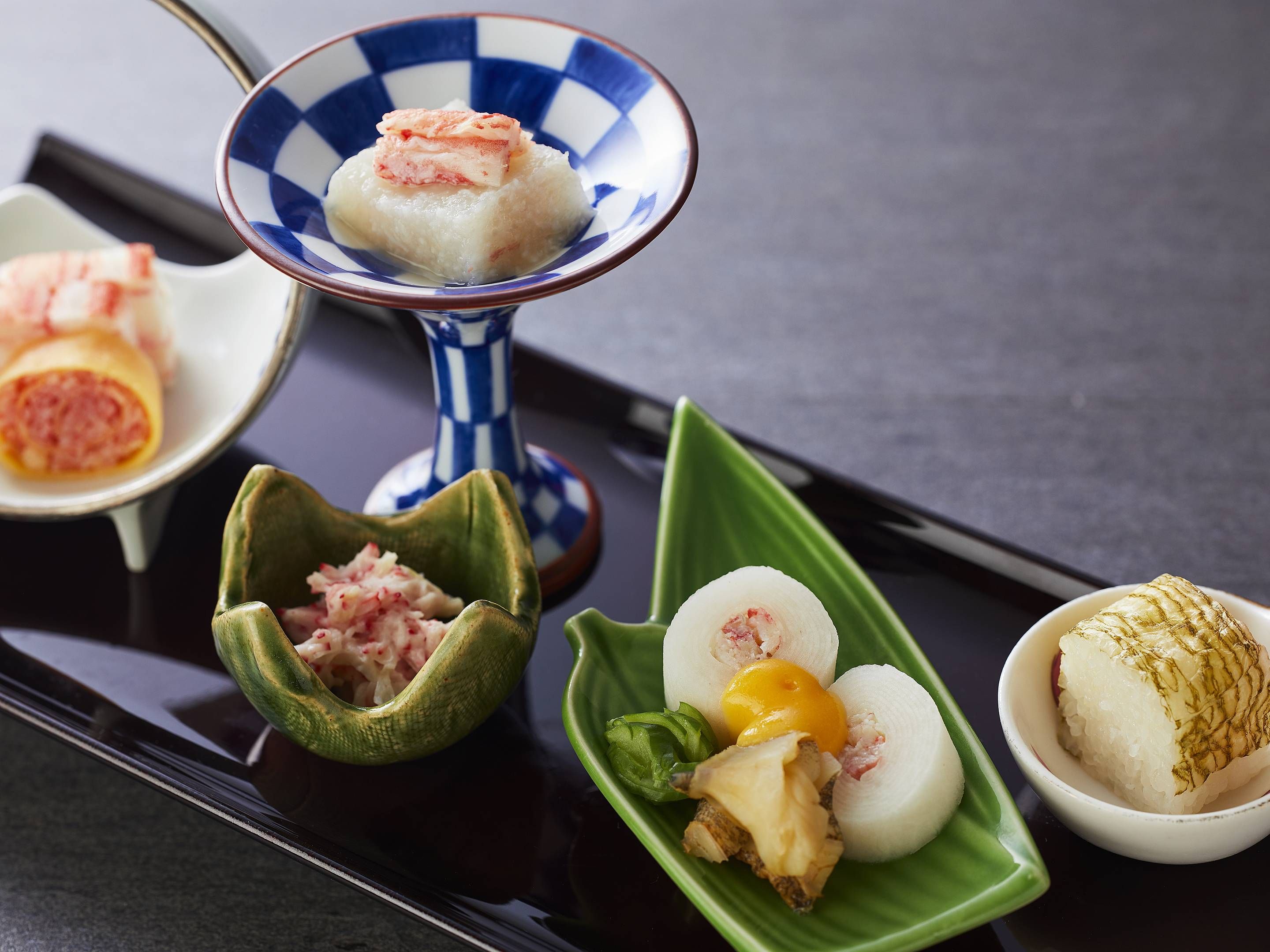A variety of Japanese dishes on a tray.