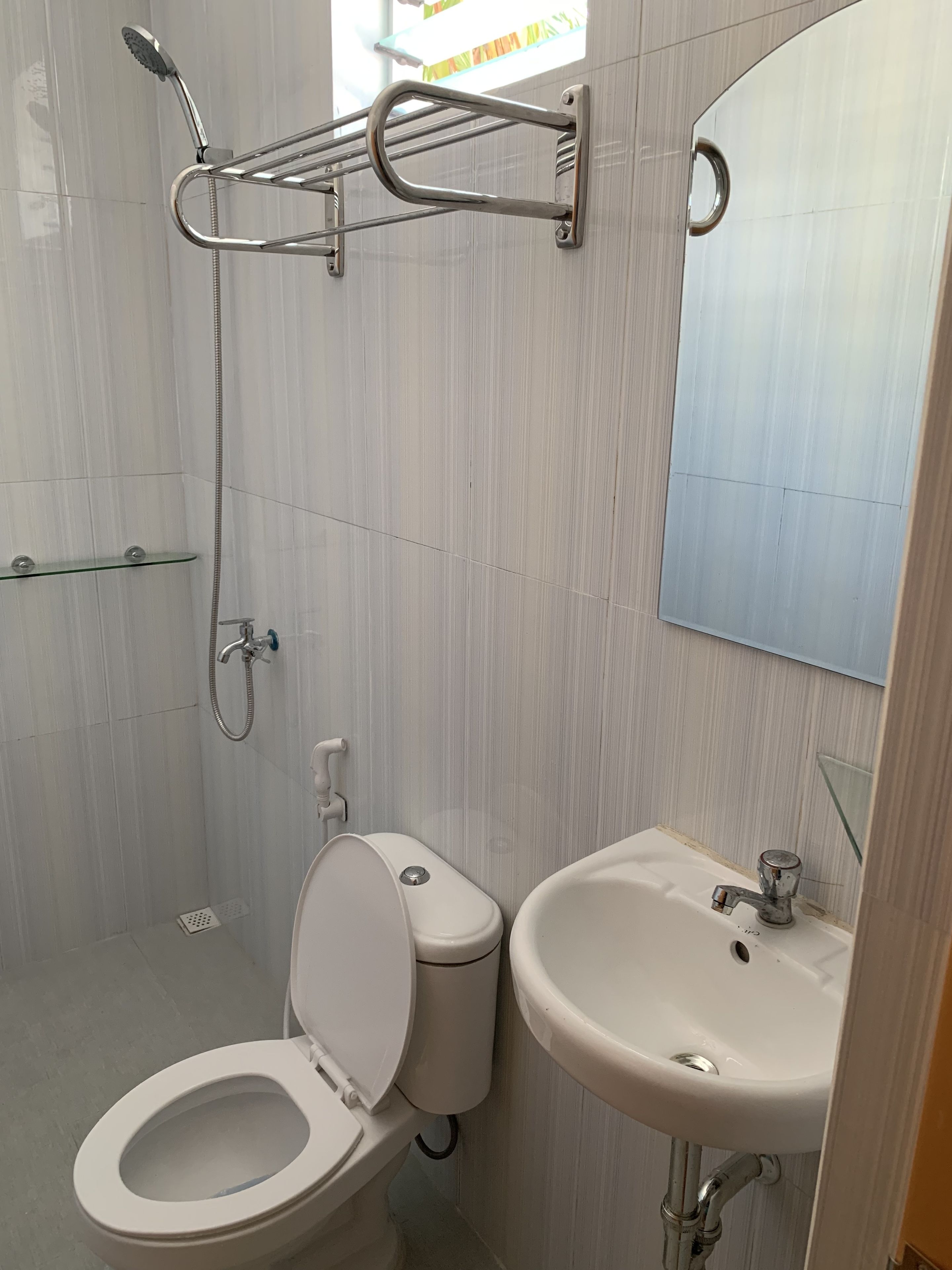 A modern bathroom with a toilet, sink, and shower.