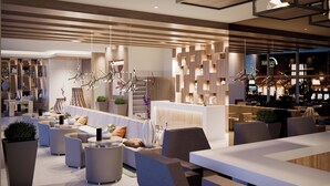 A modern hotel lobby with a reception desk, seating areas, and a bar. - AC Hotel by Marriott Santa Marta (Santa Marta)