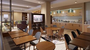 A modern dining area with wooden tables and chairs, a television, and a kitchen area with wooden cabinets and pendant lights.