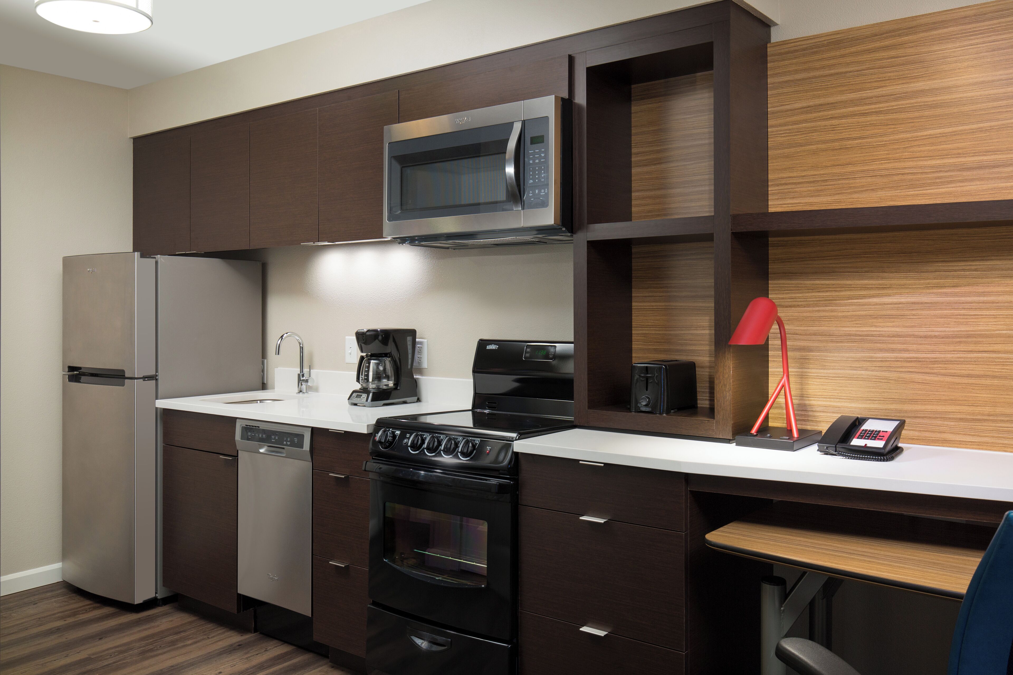 A modern kitchen with a built-in microwave, stove, and dishwasher.