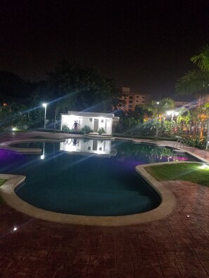 Una piscina al aire libre, tumbonas