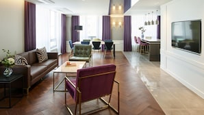 A modern living room with a sofa, chairs, a coffee table, and a TV. - Hotel Newv (Seoul)