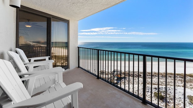 A balcony with white chairs, a view of the ocean, and a beach. - 11th Floor, Beachfront, BEST BEACH, Amazing Views, Beachside 1, Sandestin! (Miramar Beach)