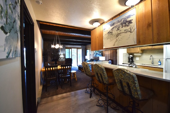 Enjoy cooking and socializing in this kitchen with a large island, bar area, and exposed beams.