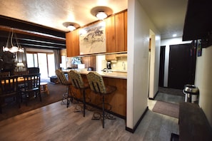 Enjoy cooking and dining in this kitchen with a sink, coffee maker, and bar seating.