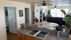 A modern kitchen with a built-in stove, wooden cabinets, and a countertop.