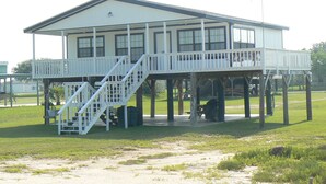 A two-story building with a balcony and a staircase leading to the upper floor.