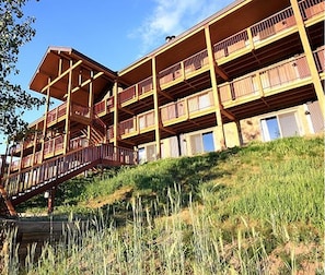 Un edificio de varios pisos con balcones y una escalera que lleva a J102.